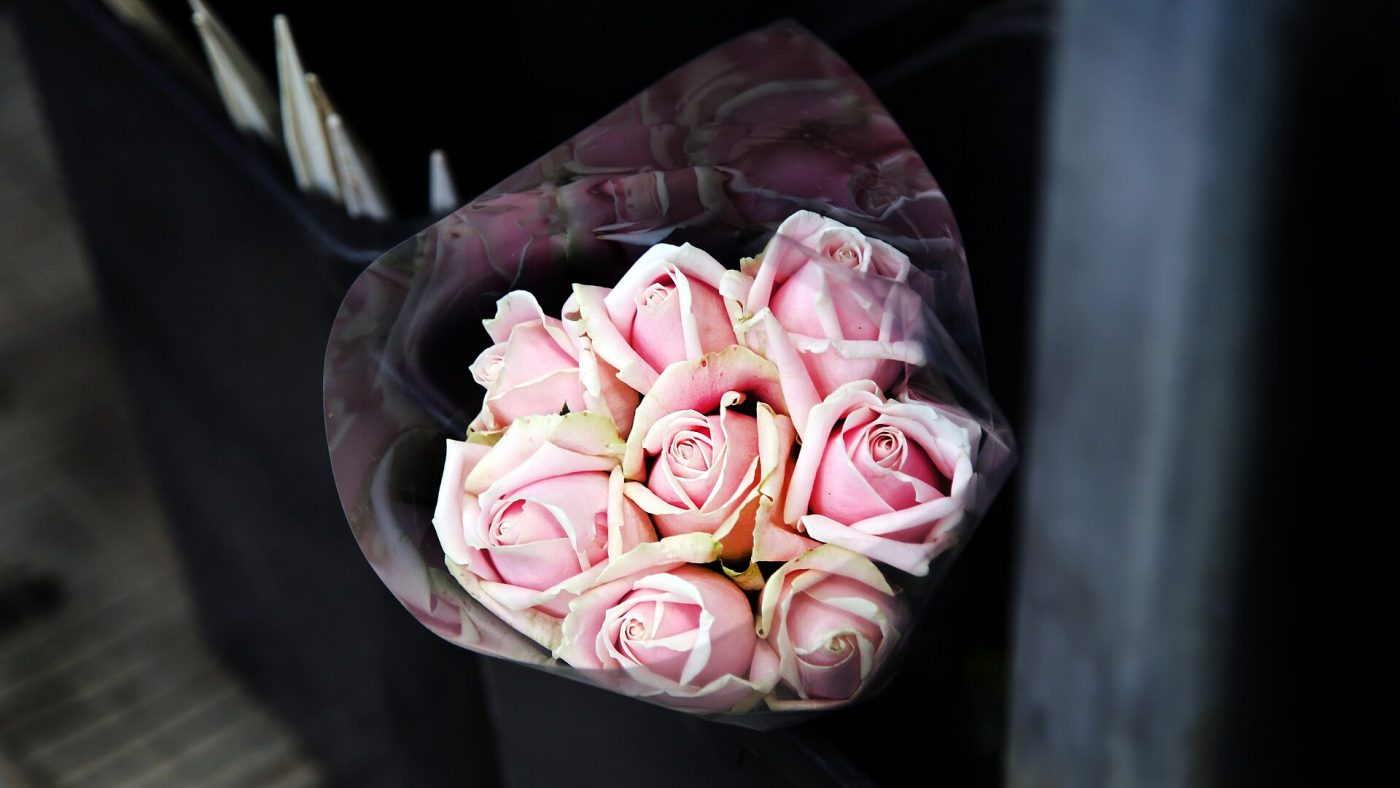 A neatly tied bouquet of fresh pink roses