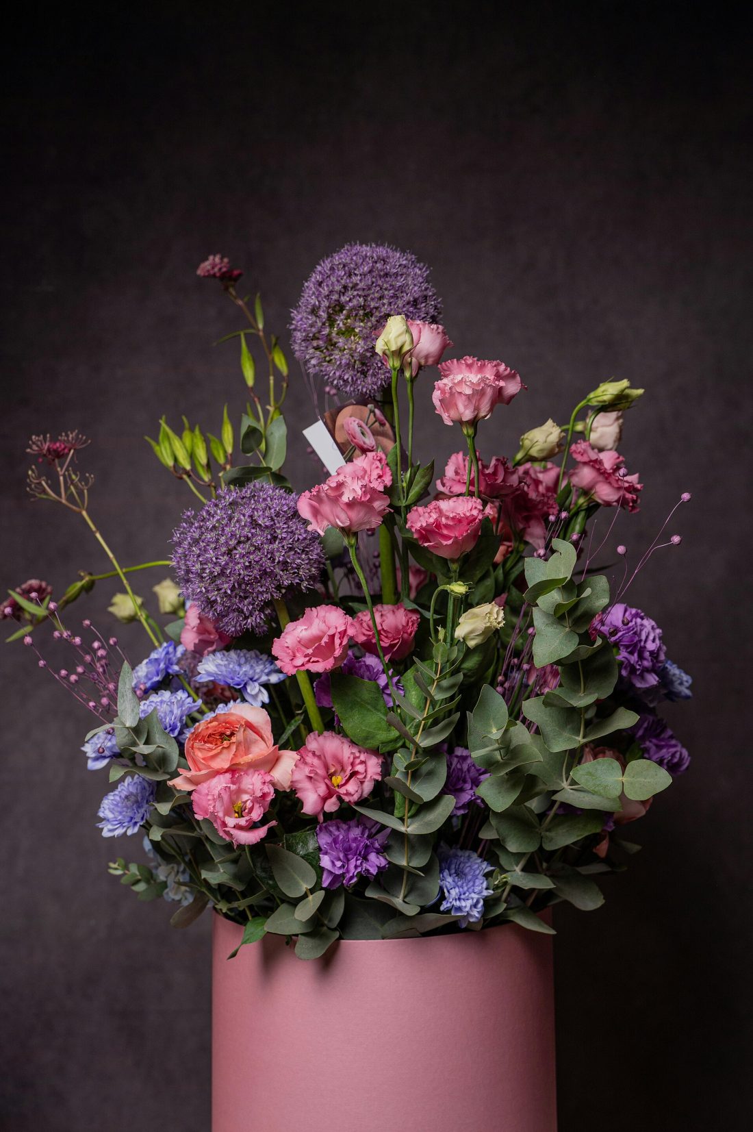 An elegant flower arrangement styled in a tall vase