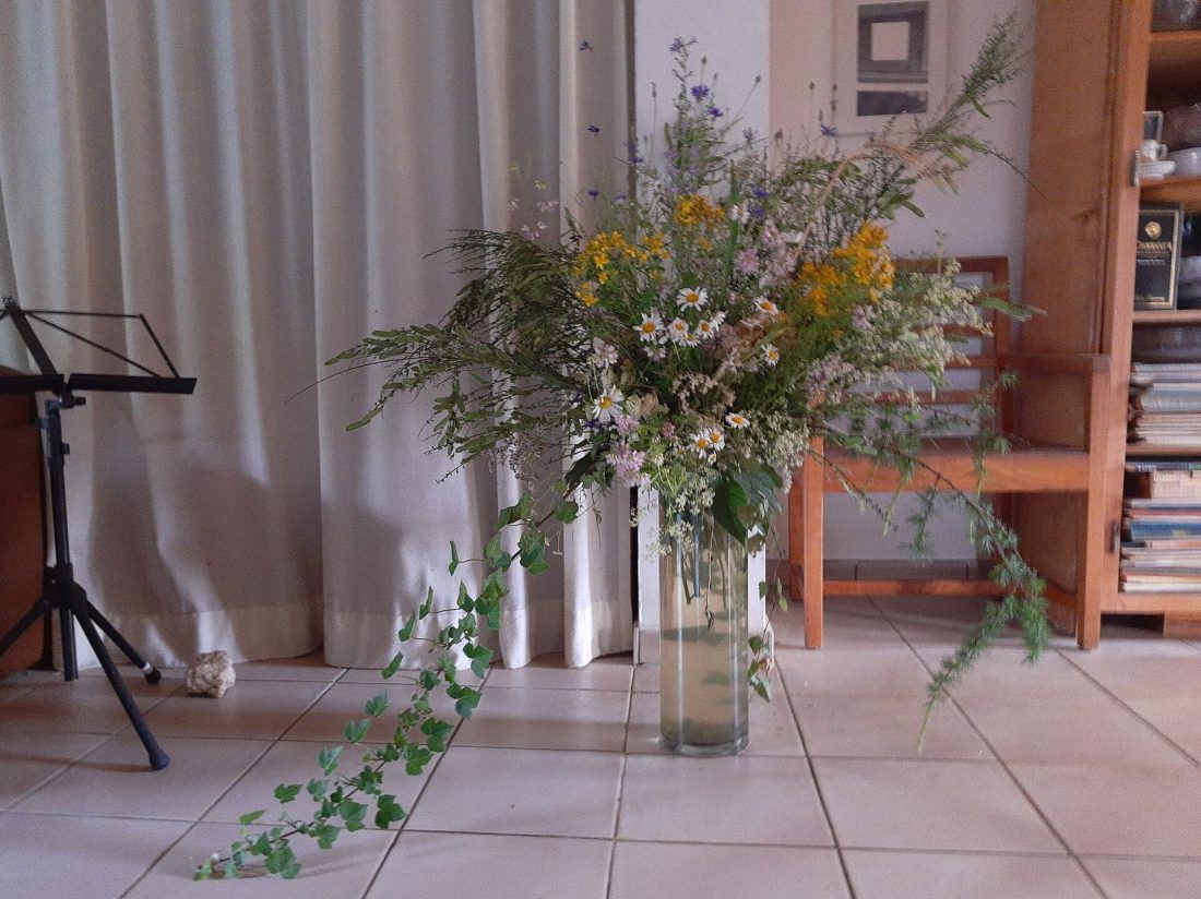 A finished decorative arrangement of wildflowers styled in a vase